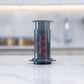 AeroPress® Original Coffee Maker with Tote Bag, Quickly makes delicious coffee without bitterness - 1 to 3 cups per pressing - Watch&Puck